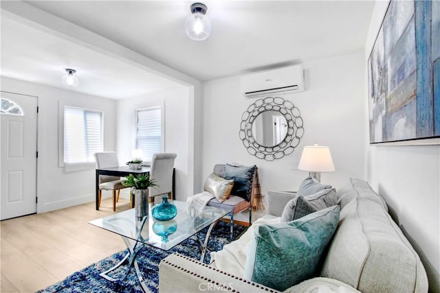 living room featuring light hardwood / wood-style floors and a wall mounted AC