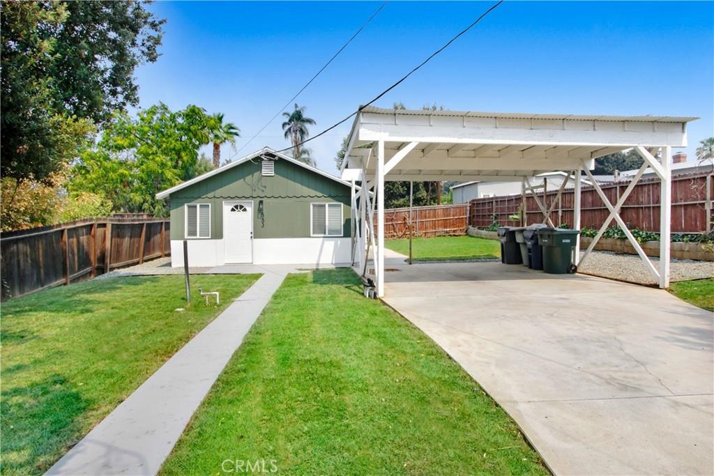 exterior space featuring a yard and a carport