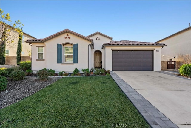 mediterranean / spanish house featuring a front yard and a garage