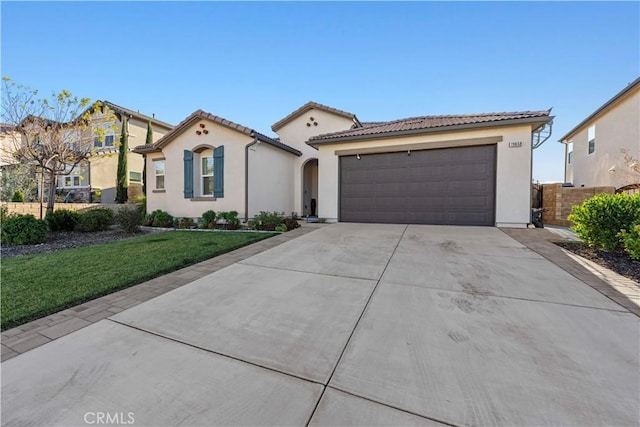 mediterranean / spanish-style home featuring a garage and a front lawn