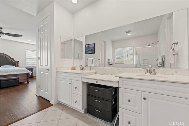 bathroom featuring vanity, ceiling fan, tile patterned flooring, and an enclosed shower