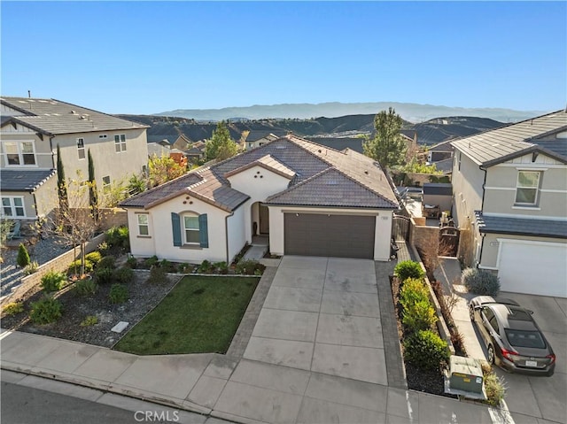 view of front of house featuring a garage and a mountain view