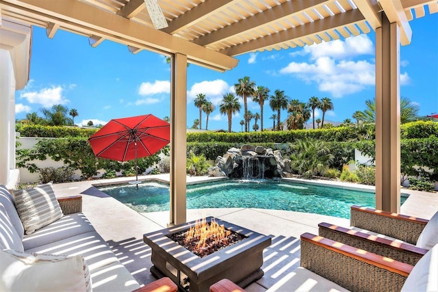 view of pool with an outdoor fire pit, a patio, pool water feature, and a pergola