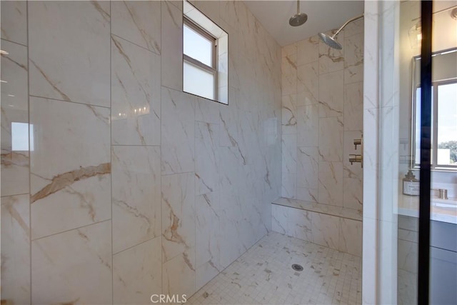 bathroom featuring a tile shower