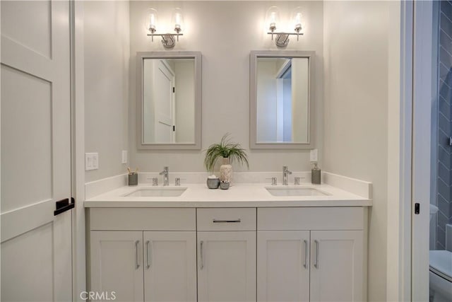 full bath featuring a sink, toilet, and double vanity