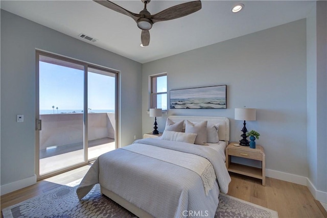 bedroom featuring access to exterior, light wood-type flooring, visible vents, and baseboards