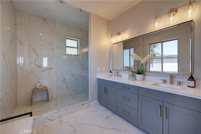 full bath with marble finish floor, a sink, a marble finish shower, and double vanity