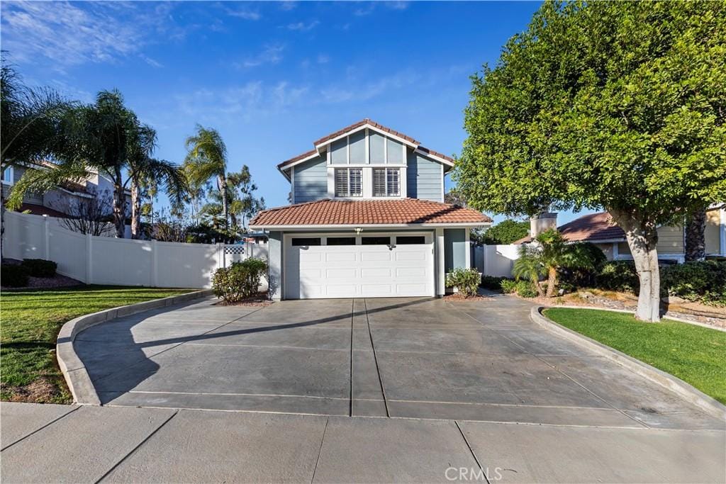 view of front of property with a front yard and a garage