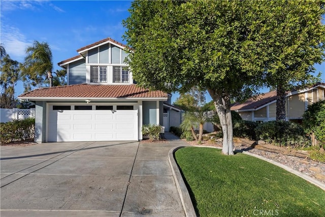 view of front of home featuring a front lawn and a garage