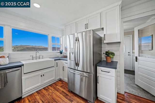 kitchen featuring sink, stainless steel appliances, and white cabinets