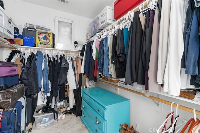 walk in closet featuring carpet