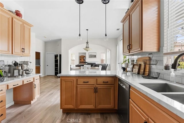 kitchen with dishwasher, kitchen peninsula, pendant lighting, sink, and tasteful backsplash