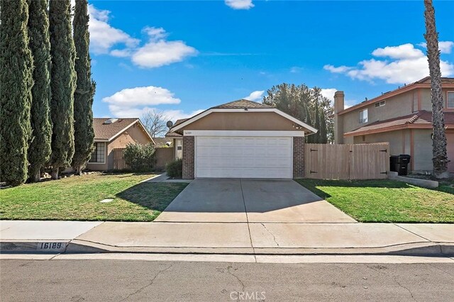 view of front of home featuring a front lawn and a garage