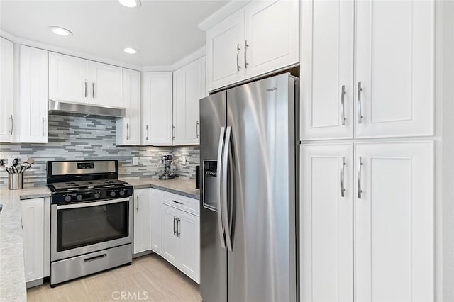 kitchen featuring light stone counters, stainless steel appliances, and white cabinetry