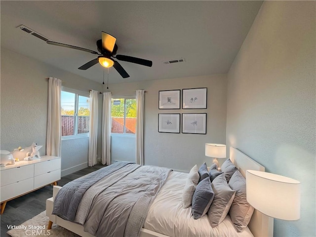 bedroom featuring dark hardwood / wood-style flooring and ceiling fan