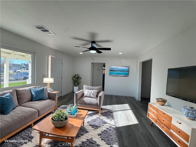 living room featuring dark hardwood / wood-style flooring and ceiling fan