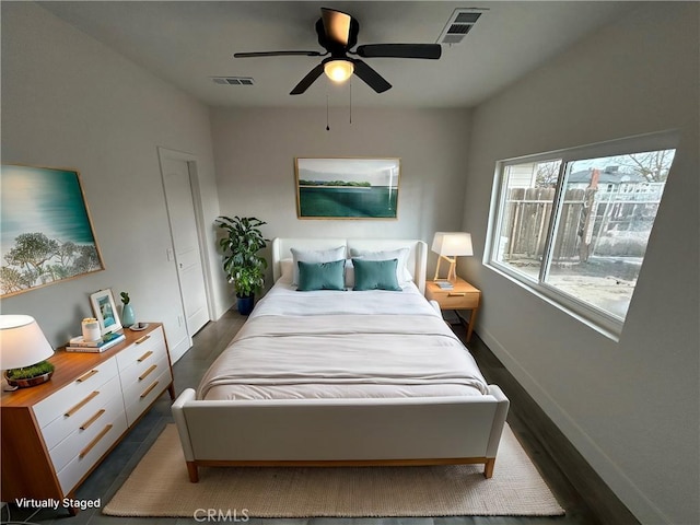 bedroom featuring ceiling fan and dark wood-type flooring