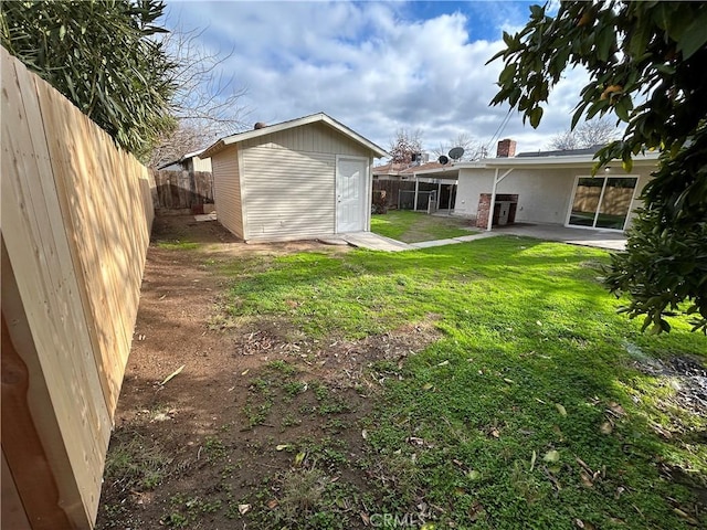 view of yard featuring a patio area and a shed