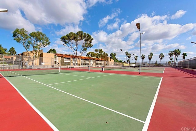 view of tennis court featuring basketball hoop