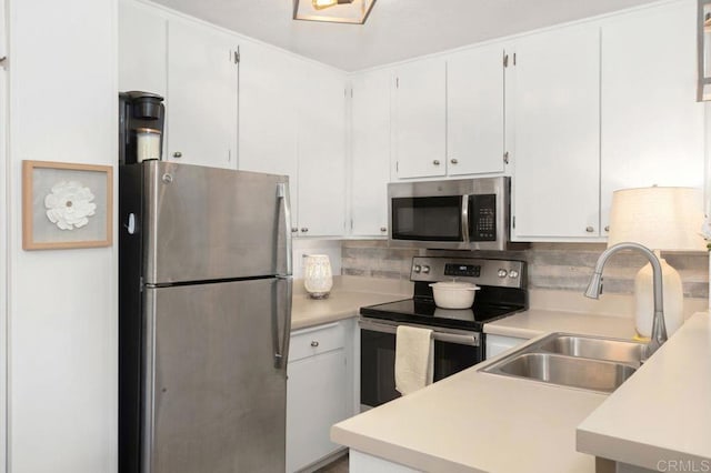 kitchen with sink, white cabinetry, appliances with stainless steel finishes, and tasteful backsplash