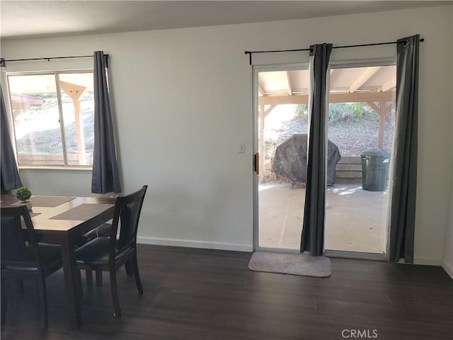 dining space with dark wood-style floors and baseboards