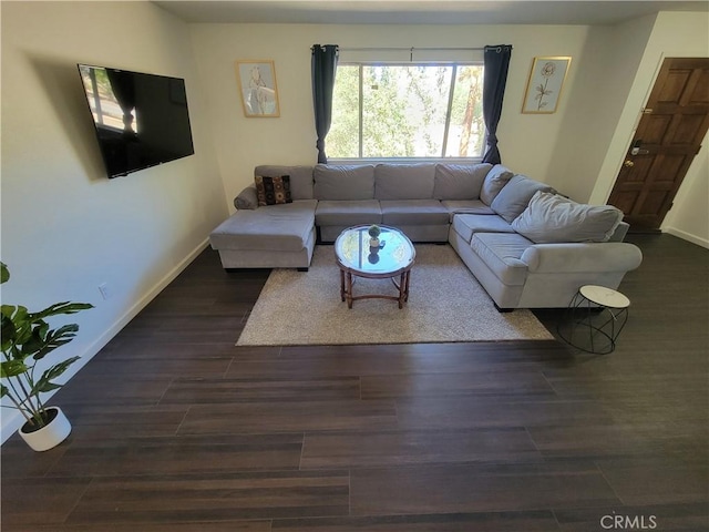 living area featuring baseboards and wood finished floors