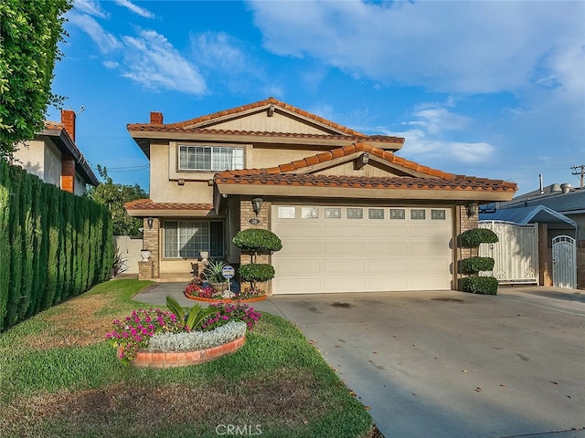 view of front facade featuring a garage, fence, concrete driveway, a gate, and stucco siding