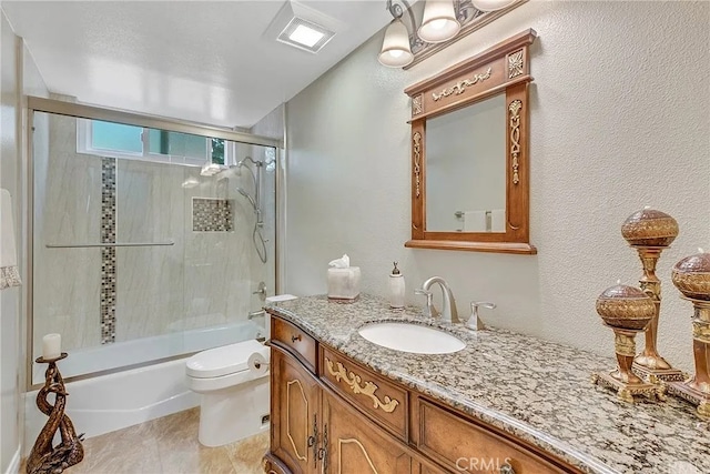 bathroom featuring a textured wall, toilet, enclosed tub / shower combo, tile patterned floors, and vanity