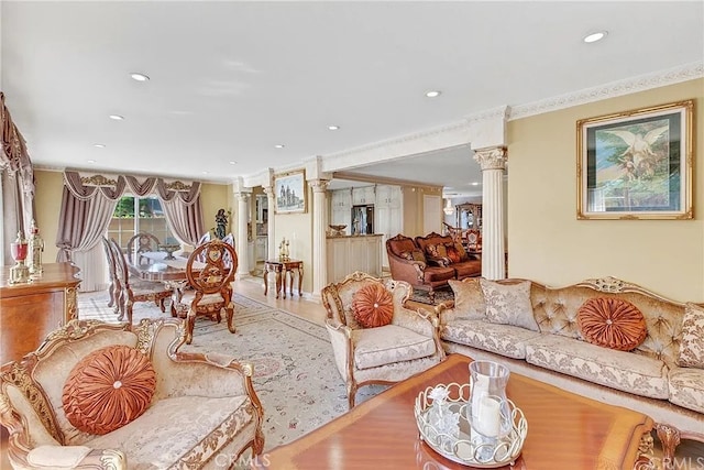 living room with recessed lighting, crown molding, ornate columns, and wood finished floors