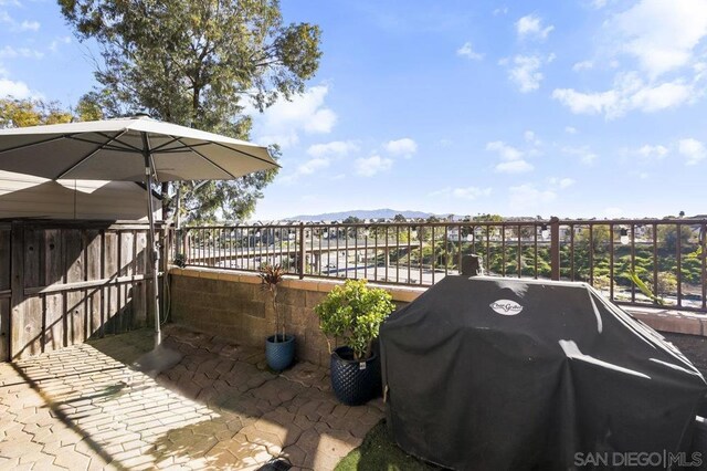 exterior space featuring a grill and a mountain view