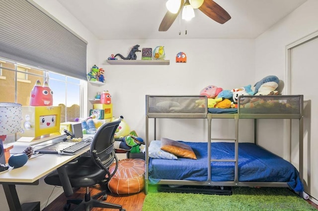 bedroom with ceiling fan and wood-type flooring