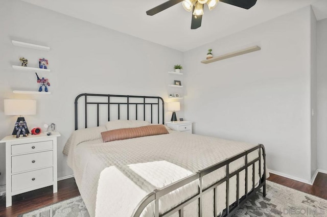 bedroom with dark hardwood / wood-style flooring and ceiling fan