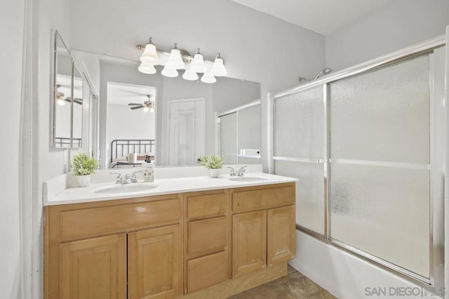 bathroom with vanity, enclosed tub / shower combo, and ceiling fan