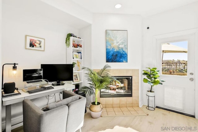 office featuring a fireplace and light hardwood / wood-style flooring