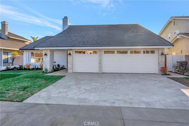 view of front of house with a front lawn and a garage