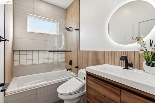 full bathroom with toilet, vanity, and tiled shower / bath