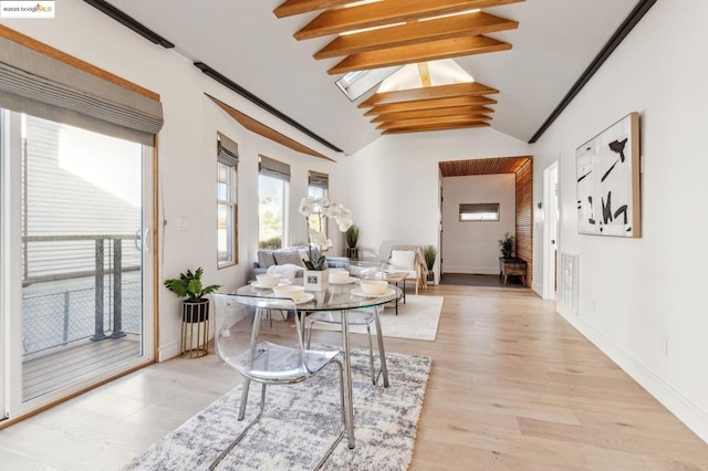 interior space featuring light hardwood / wood-style flooring and vaulted ceiling with beams