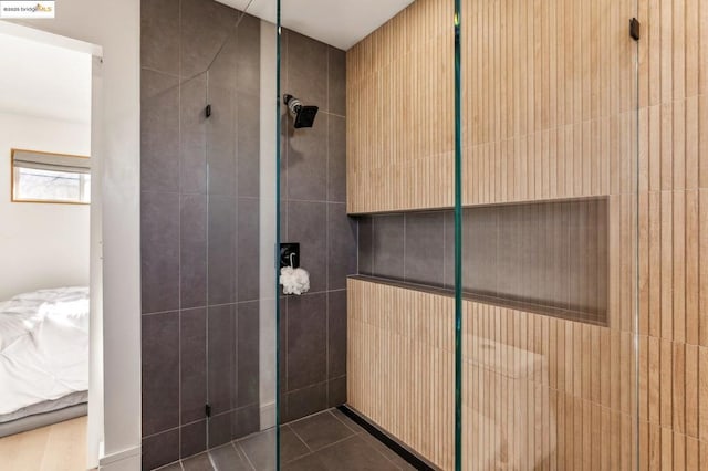 bathroom featuring tiled shower and tile patterned floors