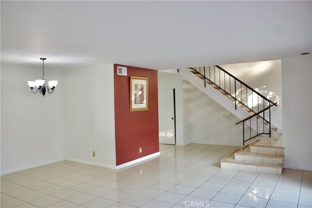 unfurnished room featuring light tile patterned floors and a notable chandelier