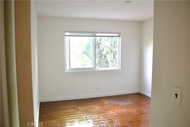 spare room with wood-type flooring