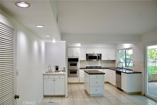 kitchen featuring sink, white cabinetry, tasteful backsplash, and appliances with stainless steel finishes