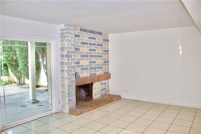 unfurnished living room with a fireplace and light tile patterned floors