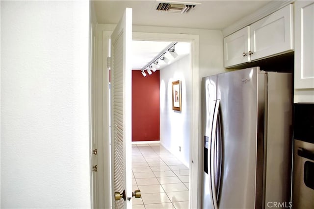 kitchen with white cabinets, track lighting, light tile patterned flooring, and stainless steel refrigerator with ice dispenser