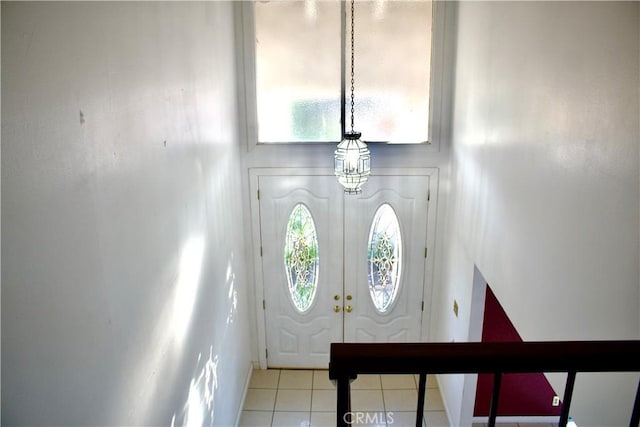 entryway featuring tile patterned flooring and french doors