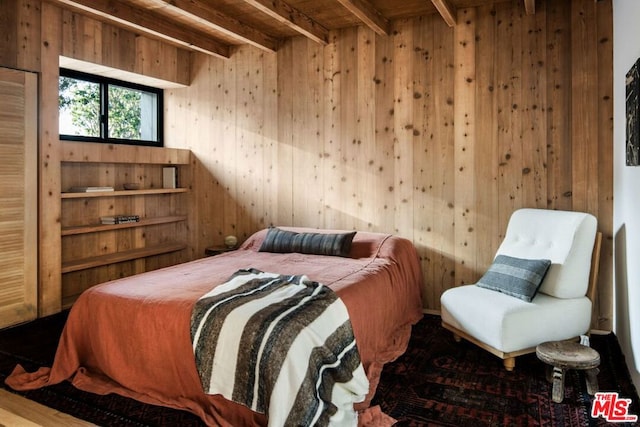 bedroom featuring wood-type flooring, wooden walls, wooden ceiling, and beamed ceiling