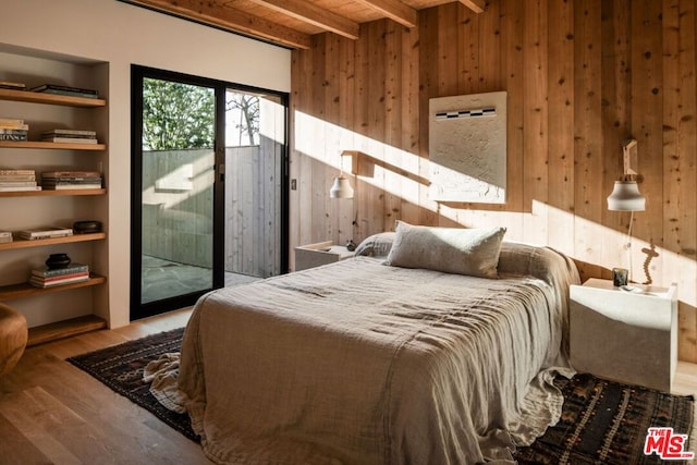 bedroom featuring wood ceiling, wood-type flooring, access to outside, wooden walls, and beamed ceiling