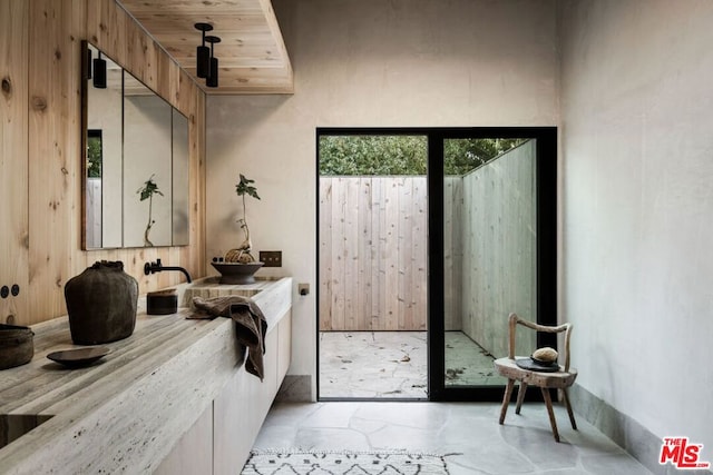 bathroom with wood ceiling and vanity