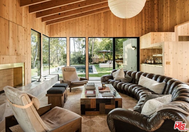 sunroom featuring vaulted ceiling with beams and a wealth of natural light