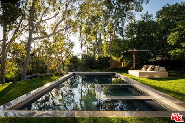 view of swimming pool featuring an outdoor living space and a lawn