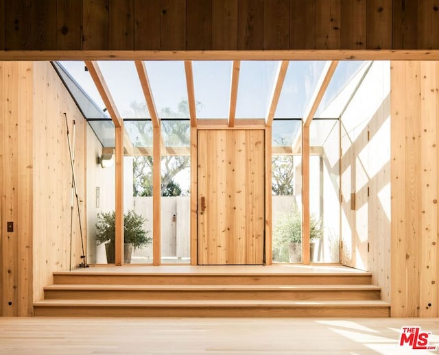 unfurnished sunroom with a skylight